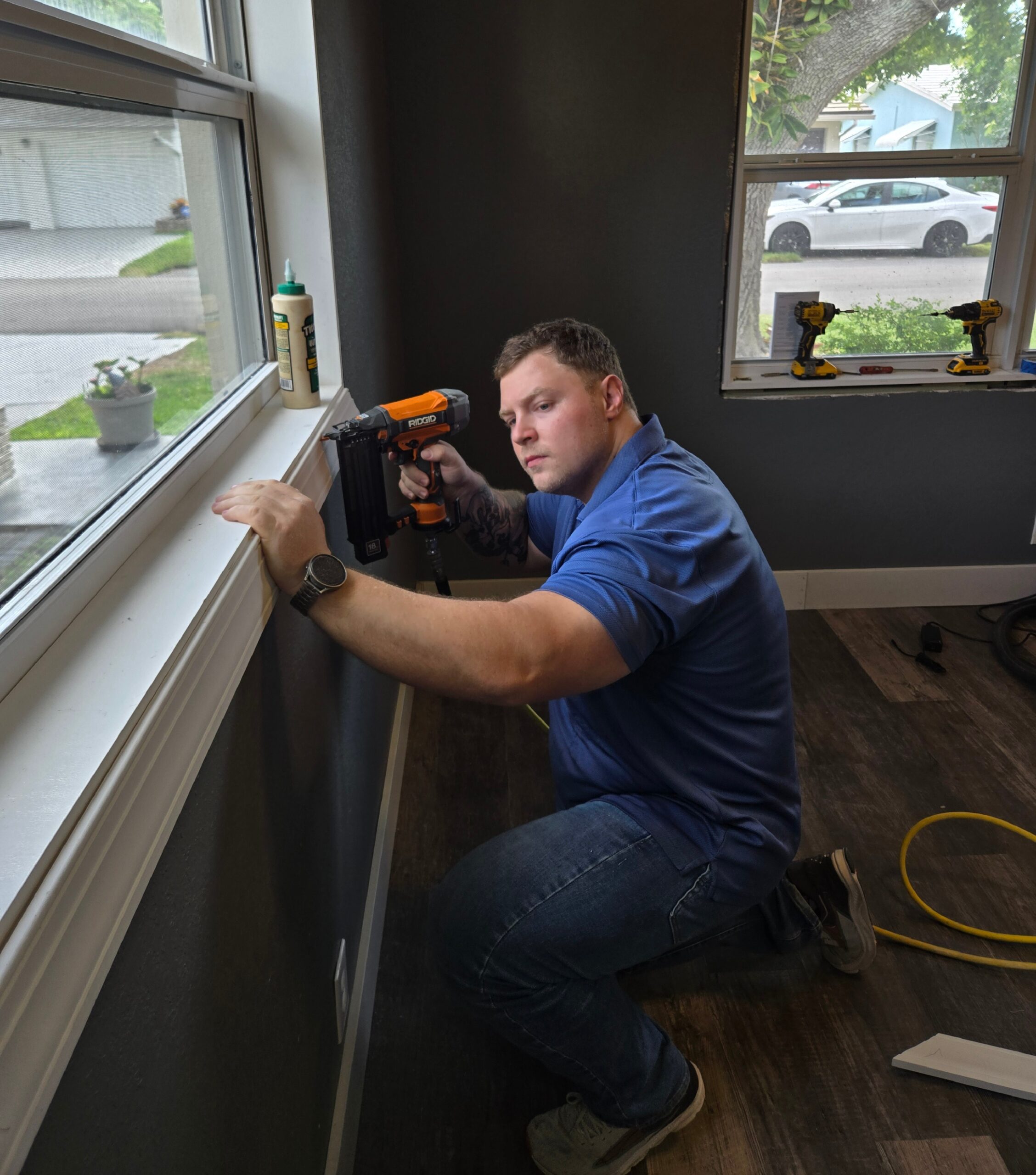 Construction worker installing window demonstrating Turnkey Builds LLC's remodeling process and standards of construction excellence.