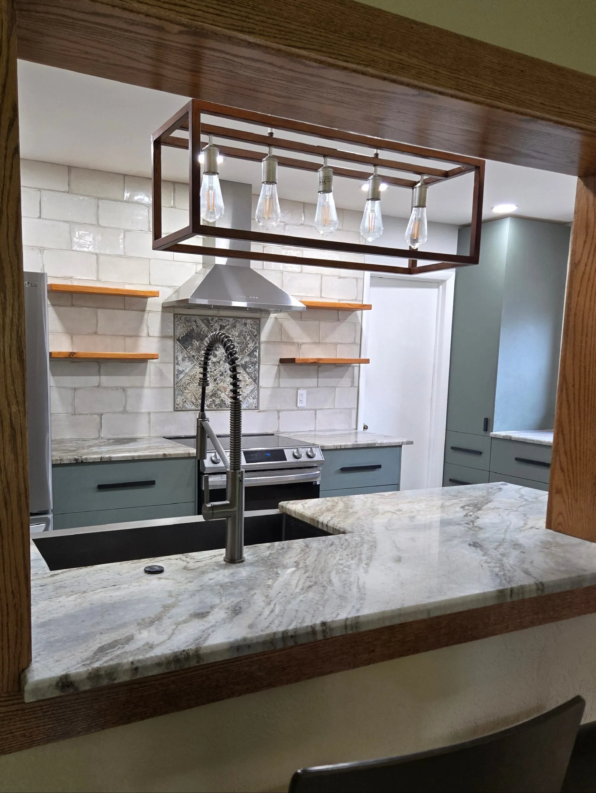 Modern South Florida kitchen renovation with open shelving, quartz countertops, and industrial pendant lighting.